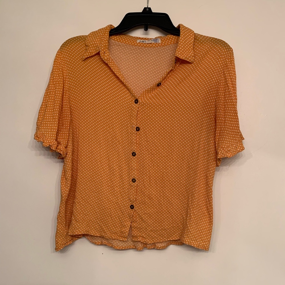 Mustard color blouse.
